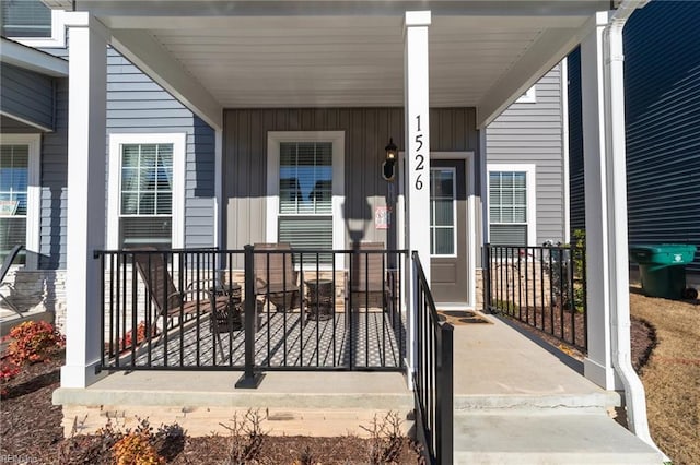 entrance to property with board and batten siding and covered porch