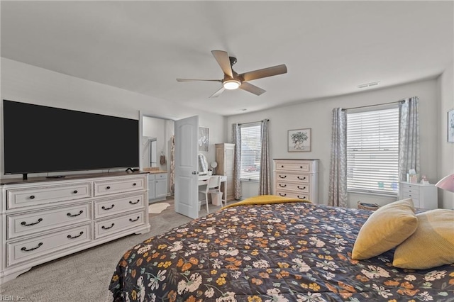 bedroom with light carpet, ensuite bath, visible vents, and a ceiling fan