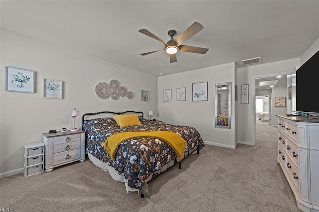 bedroom featuring a ceiling fan, light carpet, visible vents, and baseboards