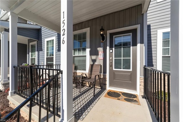 view of exterior entry with a porch