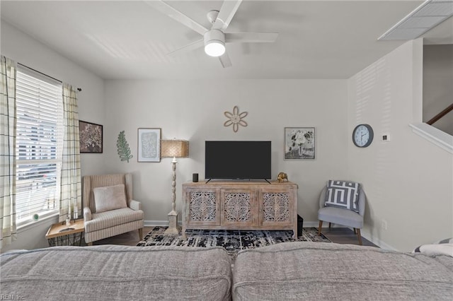 bedroom featuring ceiling fan, baseboards, and wood finished floors