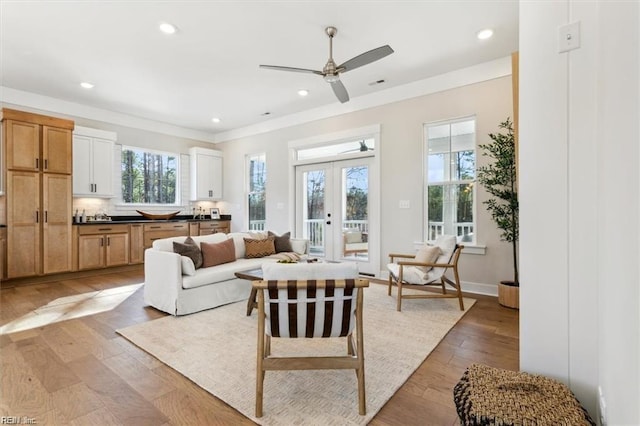 interior space featuring a ceiling fan, recessed lighting, french doors, and light wood finished floors