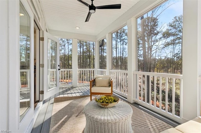 sunroom featuring a ceiling fan and a wealth of natural light