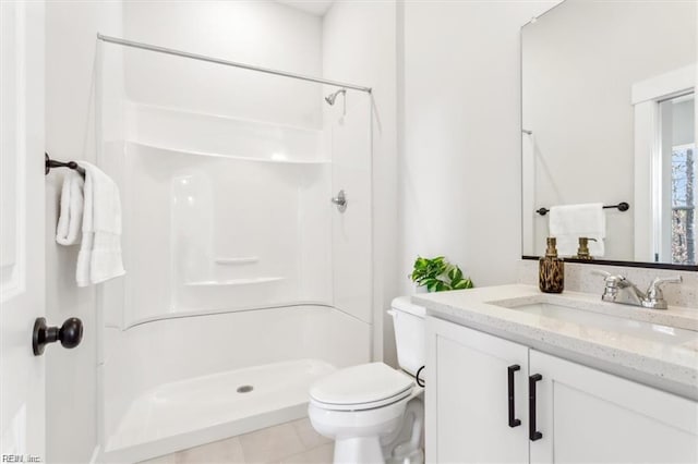 full bath featuring toilet, a shower stall, vanity, and tile patterned floors