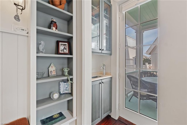 doorway featuring built in shelves and a sink