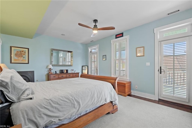 bedroom with access to exterior, visible vents, and multiple windows