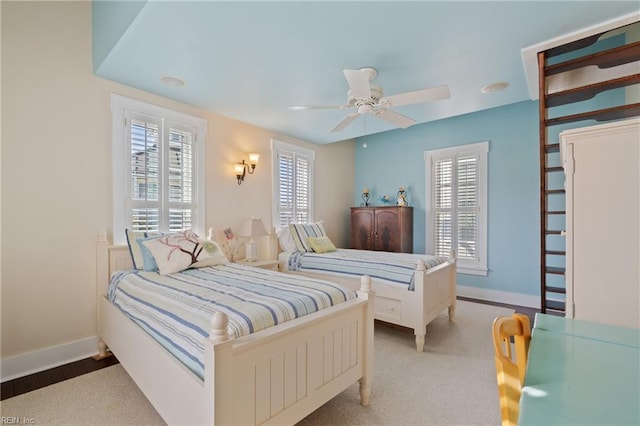 bedroom with a ceiling fan and baseboards