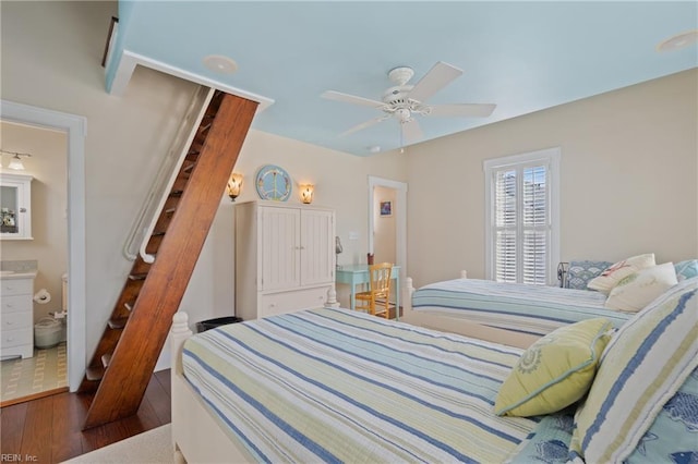 bedroom featuring ceiling fan, ensuite bathroom, and wood finished floors