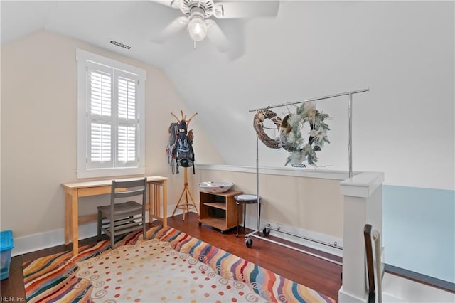 interior space featuring lofted ceiling, ceiling fan, visible vents, and wood finished floors