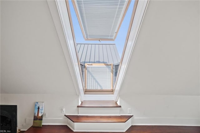 room details featuring a fireplace, wood finished floors, and baseboards