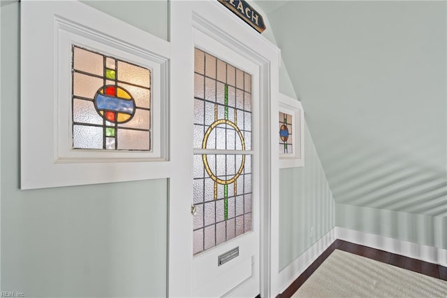 doorway with dark wood-style flooring