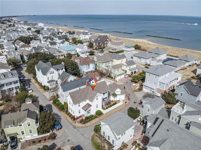 birds eye view of property with a beach view, a residential view, and a water view