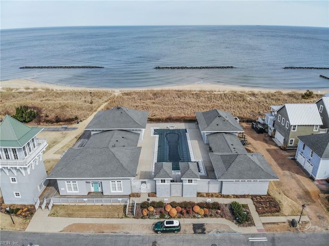 birds eye view of property with a beach view and a water view