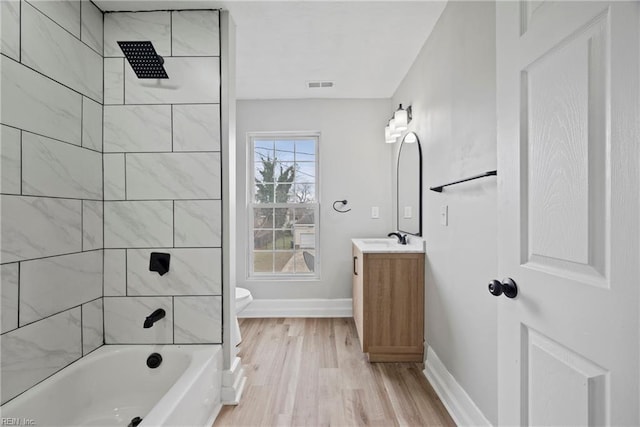 full bathroom featuring visible vents, baseboards, toilet, wood finished floors, and vanity