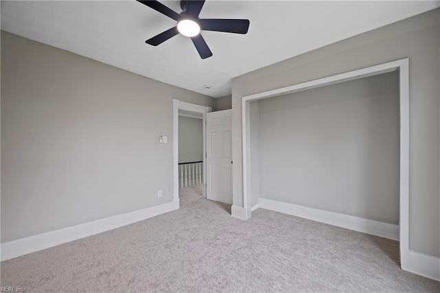 unfurnished bedroom featuring a closet, baseboards, carpet, and ceiling fan