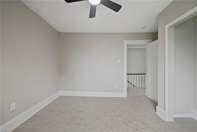 spare room featuring carpet flooring and baseboards