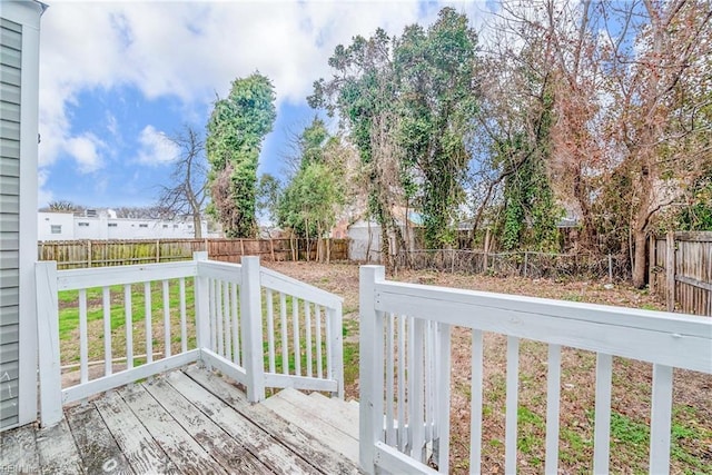 deck featuring a yard and a fenced backyard