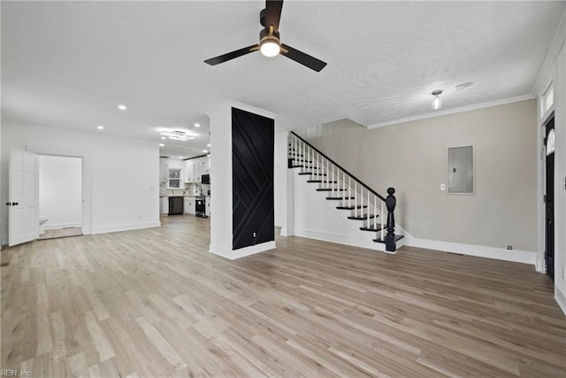 unfurnished living room featuring light wood finished floors, ceiling fan, baseboards, stairs, and electric panel