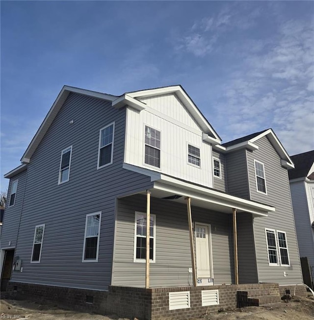 back of property featuring a porch and board and batten siding