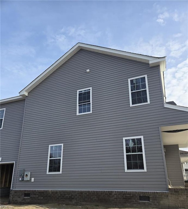 view of side of home featuring crawl space