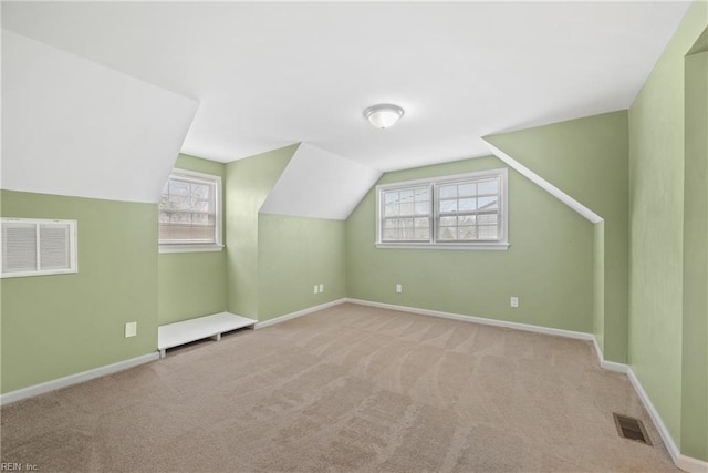 additional living space featuring carpet flooring, baseboards, and visible vents