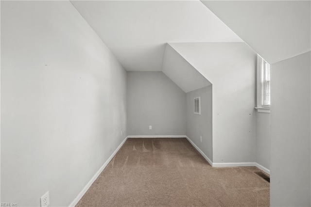 bonus room with lofted ceiling, baseboards, visible vents, and carpet floors