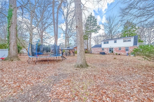 view of yard with a gazebo and a trampoline