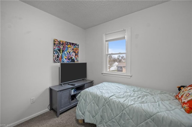 bedroom featuring carpet, baseboards, and a textured ceiling