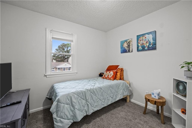 bedroom featuring a textured ceiling, carpet flooring, and baseboards