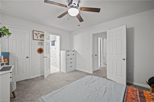 carpeted bedroom featuring a ceiling fan, a textured ceiling, and baseboards