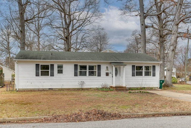 ranch-style home with a shingled roof, crawl space, driveway, and a front lawn