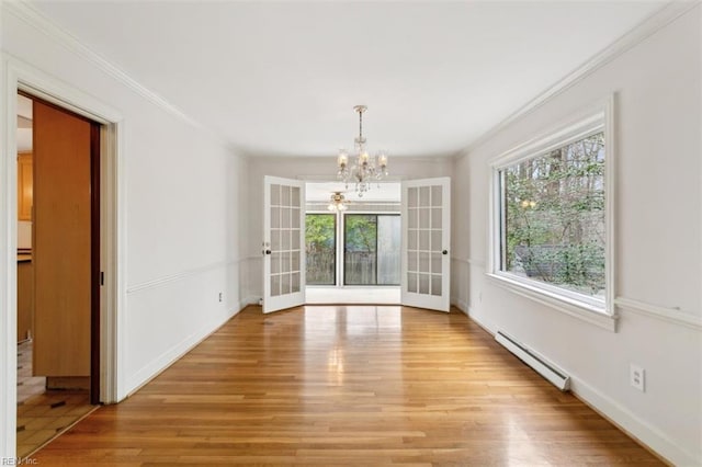 unfurnished dining area with a wealth of natural light, light wood-type flooring, french doors, and baseboard heating