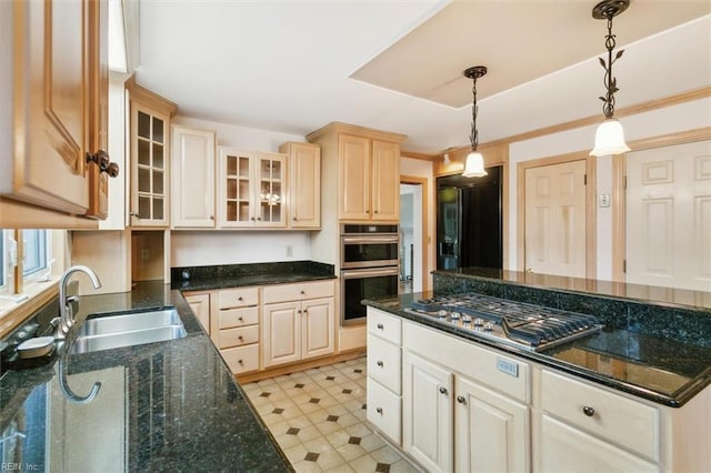 kitchen with decorative light fixtures, light floors, stainless steel appliances, glass insert cabinets, and a sink