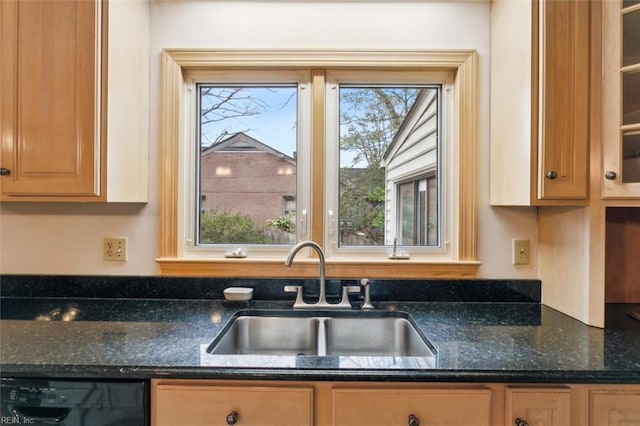 kitchen featuring dishwasher, a sink, glass insert cabinets, and a healthy amount of sunlight