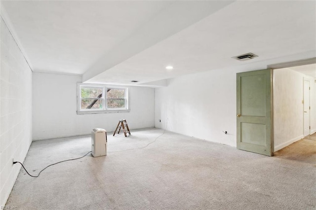 spare room featuring carpet flooring and visible vents