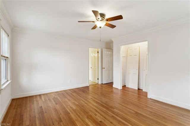 unfurnished bedroom featuring light wood-style floors, a ceiling fan, baseboards, and crown molding