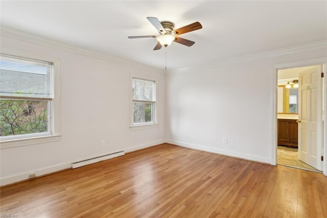 empty room with crown molding, light wood-style flooring, a baseboard heating unit, a ceiling fan, and baseboards