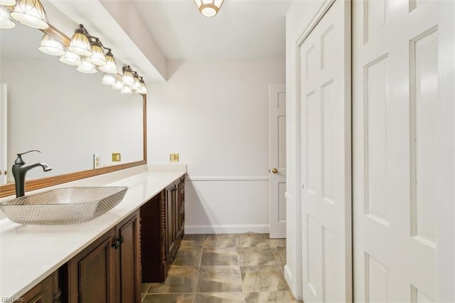 bathroom with baseboards and vanity