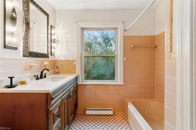 bathroom featuring a baseboard heating unit, shower / washtub combination, tile walls, and vanity