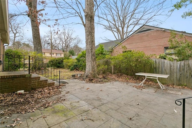 view of patio featuring fence