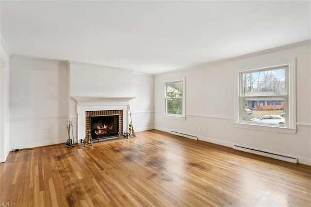 unfurnished living room with ornamental molding, baseboard heating, a fireplace, and wood finished floors