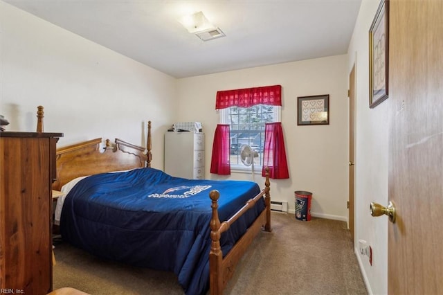 carpeted bedroom featuring a baseboard heating unit, visible vents, and baseboards