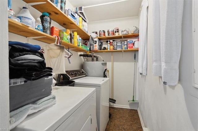 laundry room with laundry area, baseboards, gas water heater, and washer and dryer