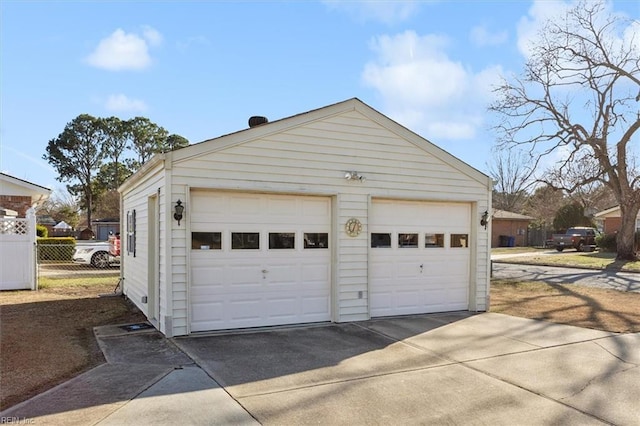 detached garage featuring fence