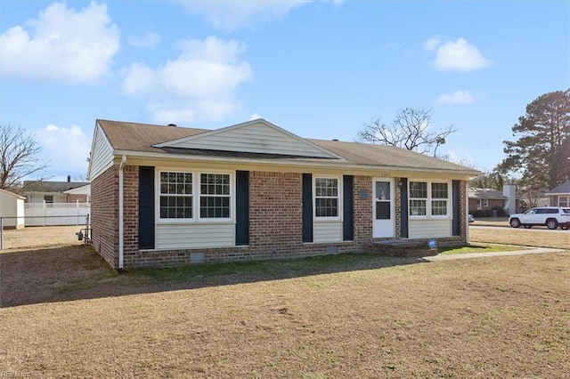 view of front facade featuring crawl space, fence, a front lawn, and brick siding