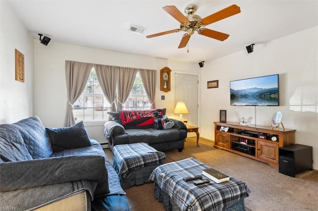 living area featuring a ceiling fan, carpet, visible vents, and baseboard heating