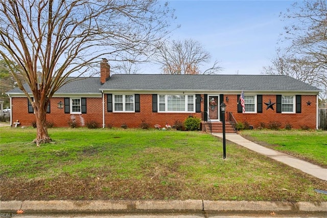 single story home featuring brick siding, roof with shingles, a chimney, a front yard, and crawl space