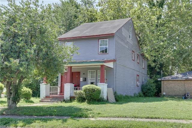 view of front of home with a porch and a front yard