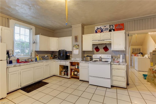 kitchen with light countertops, white cabinets, separate washer and dryer, white appliances, and under cabinet range hood