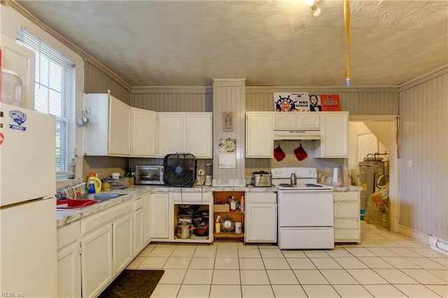 kitchen with light countertops, light tile patterned flooring, a sink, white appliances, and under cabinet range hood